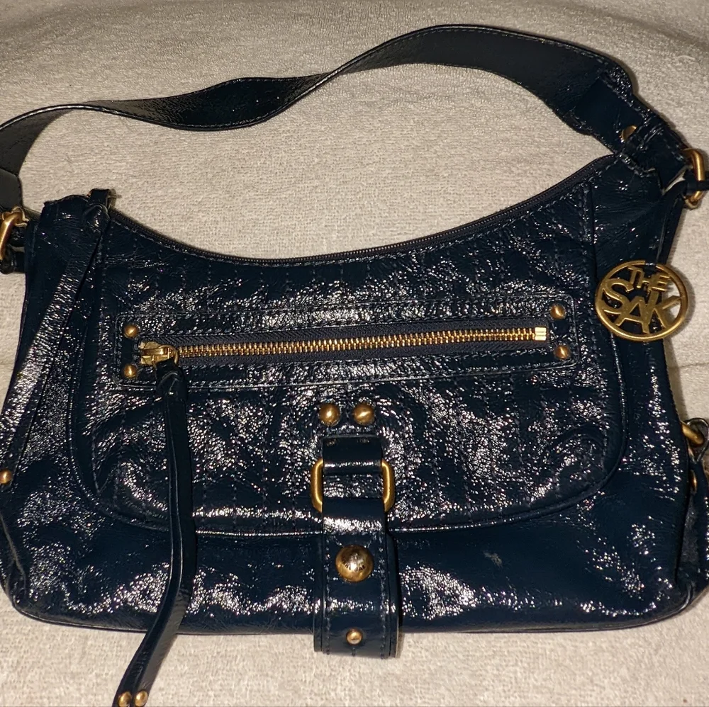 The  Sak navy blue patent leather hobo bag.